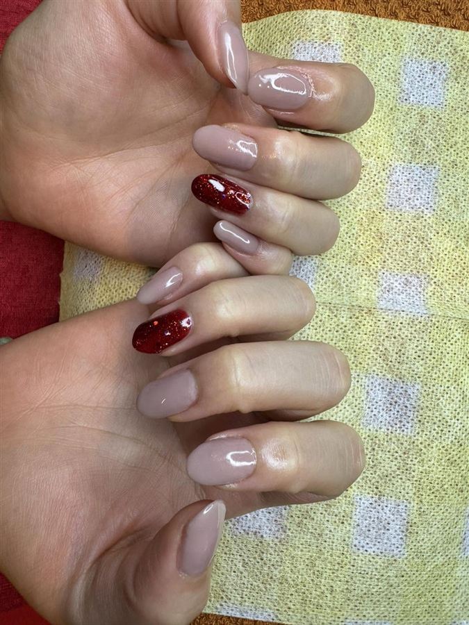 Taupe nails with a red glitter accent nail