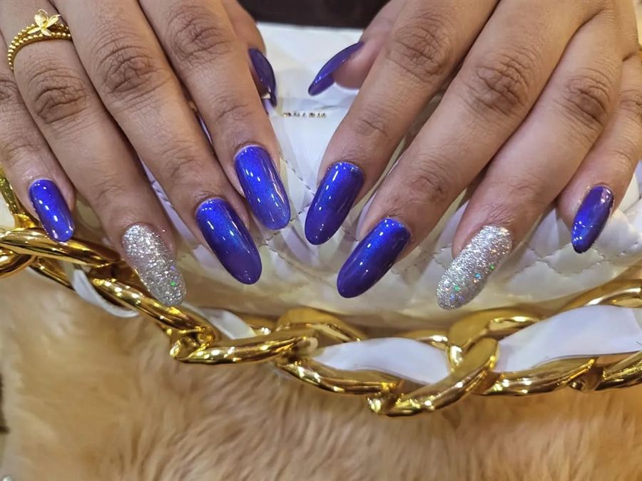 Blue shimmer nails with silver glitter accents